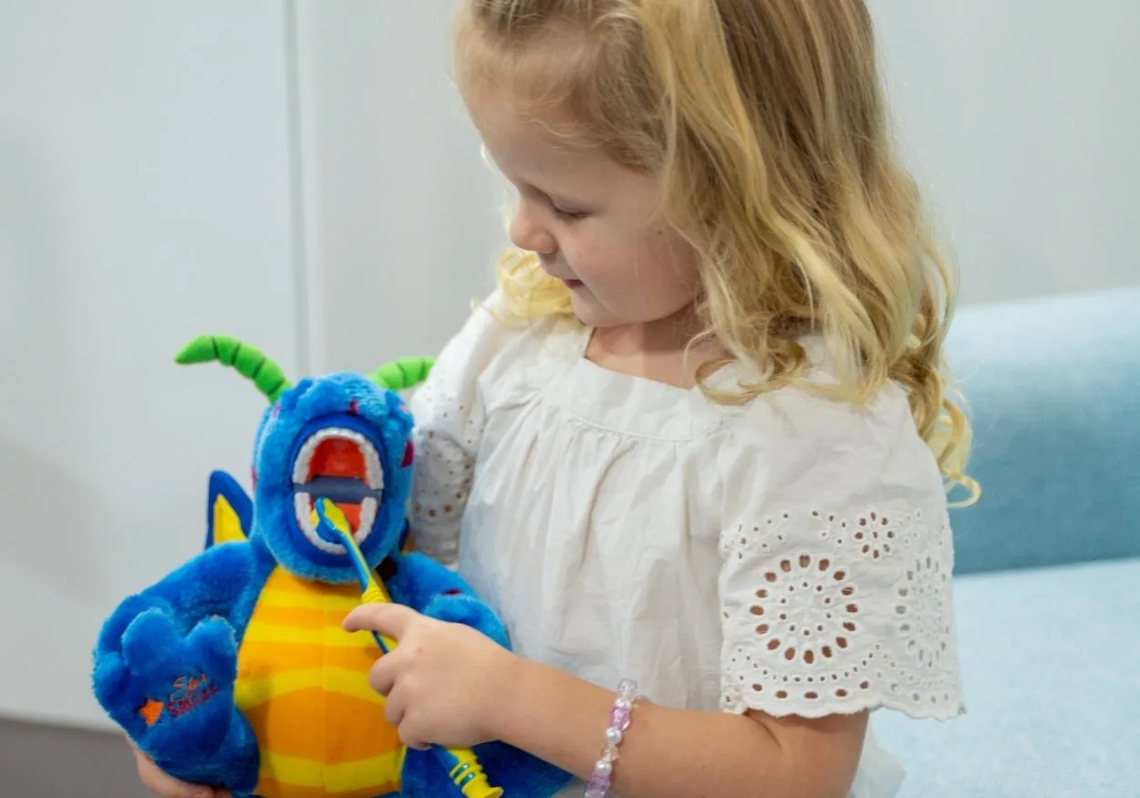 Child holding Plush Toy at the Dentist